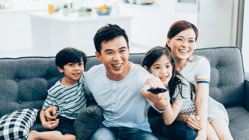 Smiling family enjoying an Educational TV show together