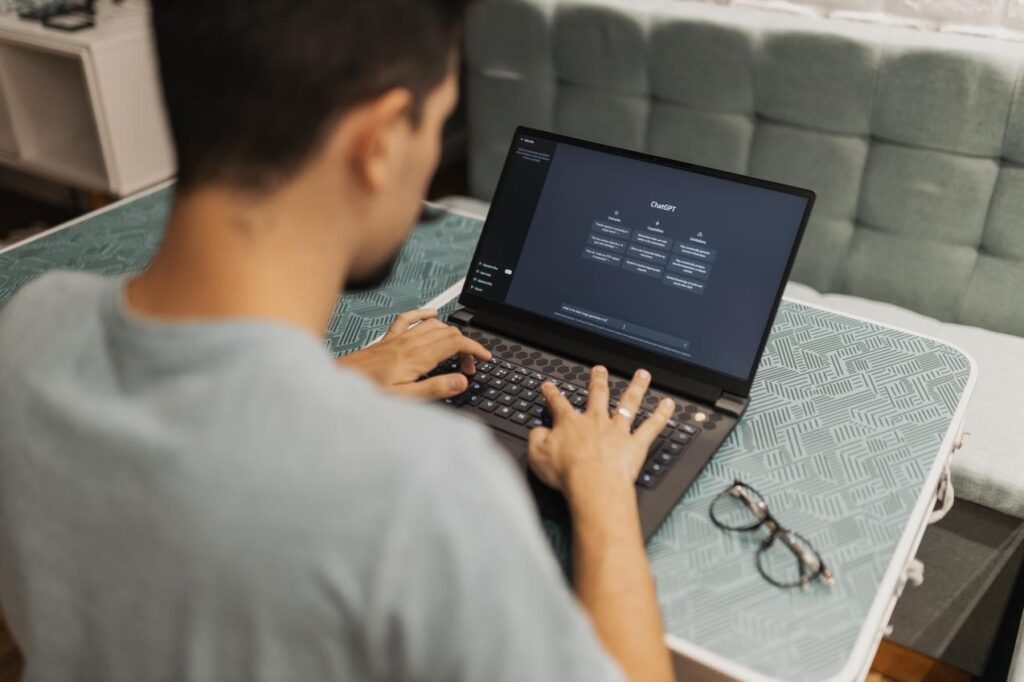 A man working on his laptop using chatGPT