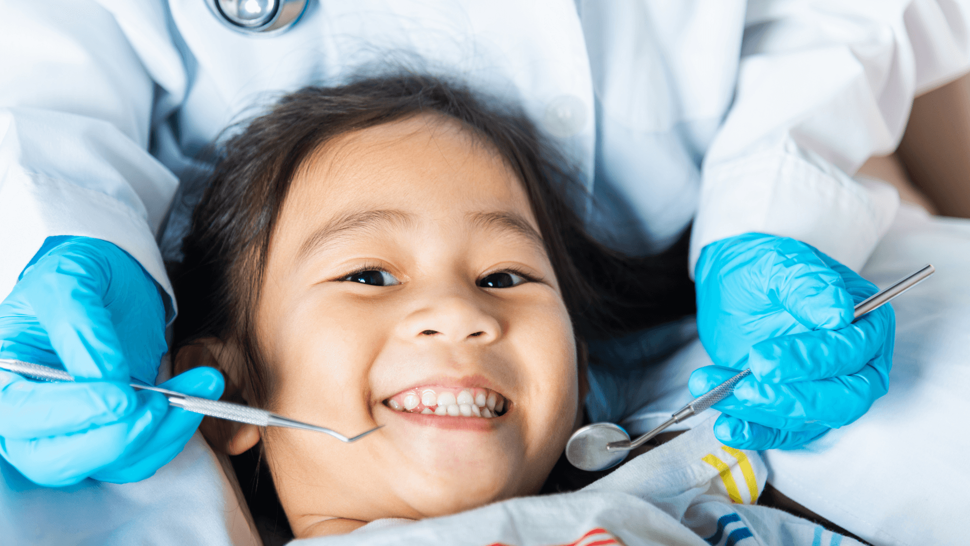 Smiling child and dentist during a successful first dental visit